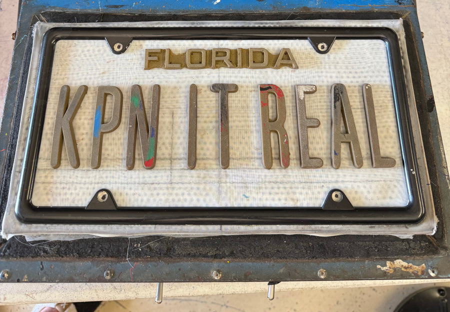 License plate mold with letters arranged for the vacuum-forming process